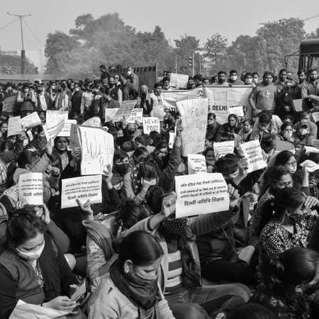 Delhi, India December 25 2021 : Delhi Contractual Guest Teachers with posters, flags and graffitiâs protesting against Delhi AAP Government for making policy, Delhi Teacher protesting Black and Whiteのeditorial素材