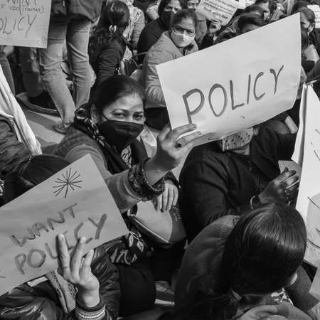 Delhi, India December 25 2021 : Delhi Contractual Guest Teachers with posters, flags and graffitiâs protesting against Delhi AAP Government for making policy, Delhi Teacher protesting Black and Whiteのeditorial素材
