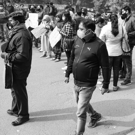 Delhi, India December 25 2021 : Delhi Contractual Guest Teachers with posters, flags and graffitiâs protesting against Delhi AAP Government for making policy, Delhi Teacher protesting Black and Whiteのeditorial素材