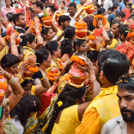 New Delhi, India April 03 2022 - Women with Kalash on head during Jagannath Temple Mangal Kalash...