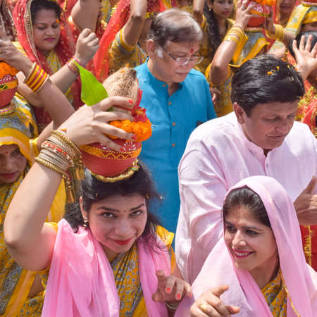 New Delhi, India April 03 2022 - Women with Kalash on head during Jagannath Temple Mangal Kalash...