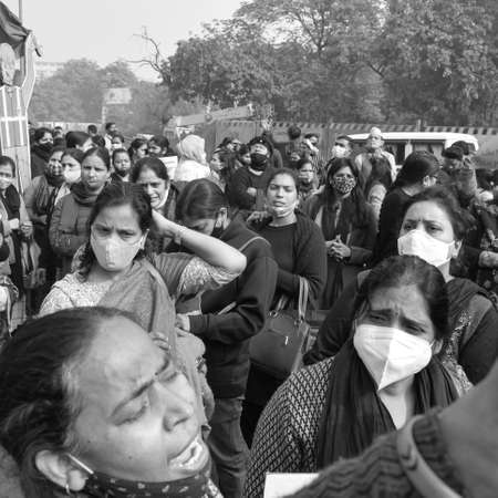 Delhi, India December 25 2021 : Delhi Contractual Guest Teachers with posters, flags and graffitiâs protesting against Delhi AAP Government for making policy, Delhi Teacher protesting Black and Whiteのeditorial素材