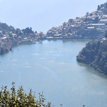 Full view of Naini Lake during evening time near Mall Road in Nainital, Uttarakhand, India, Beautiful view of Nainital Lake with mountains and blue skyの写真素材