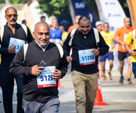 New Delhi, India - October 16 2022 - Vedanta Delhi Half Marathon race after covid in which marathon participants about to cross the finish line, Delhi Half Marathon 2022のeditorial素材