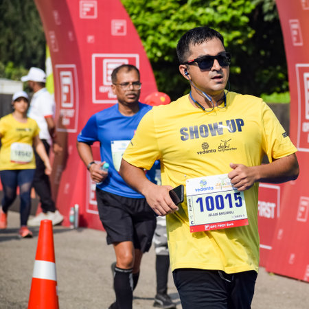 New Delhi, India - October 16 2022 - Vedanta Delhi Half Marathon race after covid in which marathon participants about to cross the finish line, Delhi Half Marathon 2022のeditorial素材