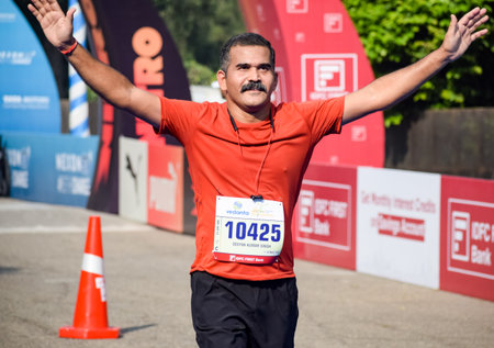 New Delhi, India - October 16 2022 - Vedanta Delhi Half Marathon race after covid in which marathon participants about to cross the finish line, Delhi Half Marathon 2022のeditorial素材