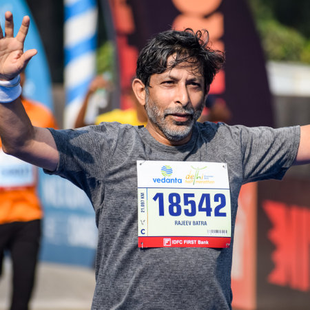 New Delhi, India - October 16 2022 - Vedanta Delhi Half Marathon race after covid in which marathon participants about to cross the finish line, Delhi Half Marathon 2022のeditorial素材