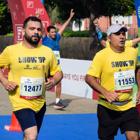 New Delhi, India - October 16 2022 - Vedanta Delhi Half Marathon race after covid in which marathon participants about to cross the finish line, Delhi Half Marathon 2022のeditorial素材