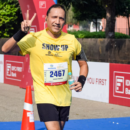 New Delhi, India - October 16 2022 - Vedanta Delhi Half Marathon race after covid in which marathon participants about to cross the finish line, Delhi Half Marathon 2022のeditorial素材