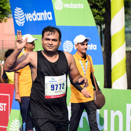 New Delhi, India - October 16 2022 - Vedanta Delhi Half Marathon race after covid in which marathon participants about to cross the finish line, Delhi Half Marathon 2022のeditorial素材