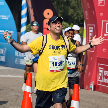 New Delhi, India - October 16 2022 - Vedanta Delhi Half Marathon race after covid in which marathon participants about to cross the finish line, Delhi Half Marathon 2022のeditorial素材