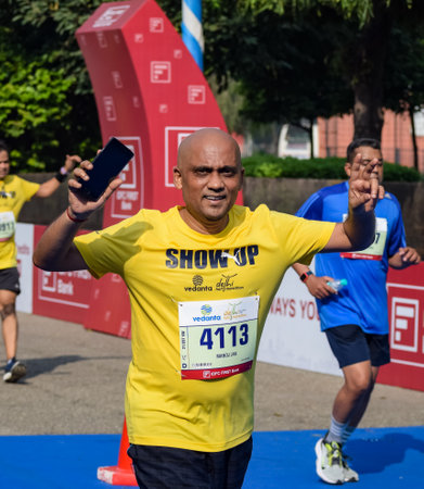 New Delhi, India - October 16 2022 - Vedanta Delhi Half Marathon race after covid in which marathon participants about to cross the finish line, Delhi Half Marathon 2022のeditorial素材