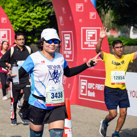 New Delhi, India - October 16 2022 - Vedanta Delhi Half Marathon race after covid in which marathon participants about to cross the finish line, Delhi Half Marathon 2022のeditorial素材