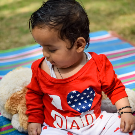 Cute little Indian infant sitting enjoying outdoor shoot at society park in Delhi, Cute baby boy...