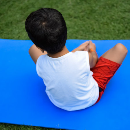 Asian smart kid doing yoga pose in the society park outdoor, Children's yoga pose. The little boy doing Yoga exerciseの写真素材