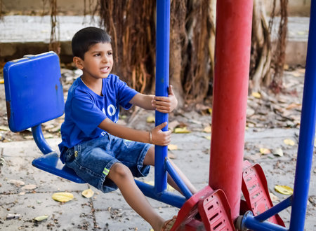 Asian boy doing routine exercise in society park during the morning time. Cute little kid exercise and gym to keep himself fit for life. Child's exercise outdoor shootの写真素材