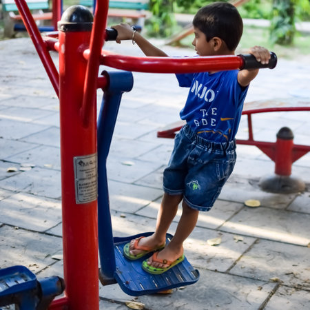 Asian boy doing routine exercise in society park during the morning time. Cute little kid exercise and gym to keep himself fit for life. Child's exercise outdoor shootの写真素材