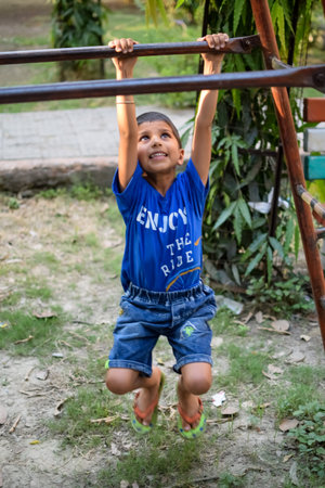 Asian smart kid doing yoga pose in the society park outdoor, Children's yoga pose. The little boy...
