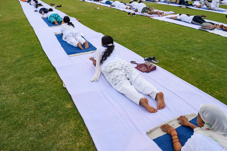 New Delhi, India, June 21, 2023 - Group Yoga exercise session for people at Yamuna Sports Complex in...
