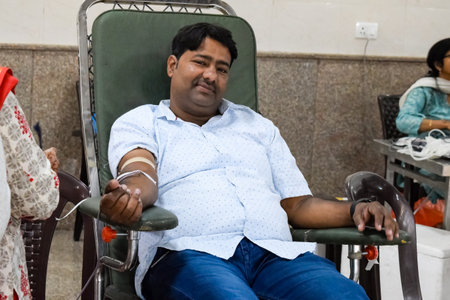 Delhi, India, June 19 2023 - Blood donor at Blood donation camp held at Balaji Temple, Vivek Vihar, Delhi, India, Image for World blood donor day on June 14 every year, Blood Donation Camp at Templeのeditorial素材