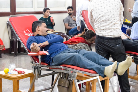 Delhi, India, June 19 2023 - Blood donor at Blood donation camp held at Balaji Temple, Vivek Vihar, Delhi, India, Image for World blood donor day on June 14 every year, Blood Donation Camp at Templeのeditorial素材