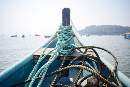 Amazing view from over long tail motor boat in Arabian sea in Goa, India, Ocean view from wooden boat with old ropesの写真素材