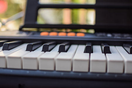 Close-up of piano keys. Piano black and white keys and Piano keyboard musical instrument placed at the home balcony during sunny day.の写真素材