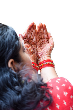 Beautiful woman dressed up as Indian tradition with henna mehndi design on her both hands to celebrate big festival of Karwa Chauth with plain white backgroundの写真素材