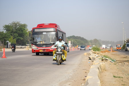 New Delhi, India - April 16, 2023 - View of Vehicles passing through the main road near Indra Gandhi International Airport Delhi at Dwarka link roadのeditorial素材