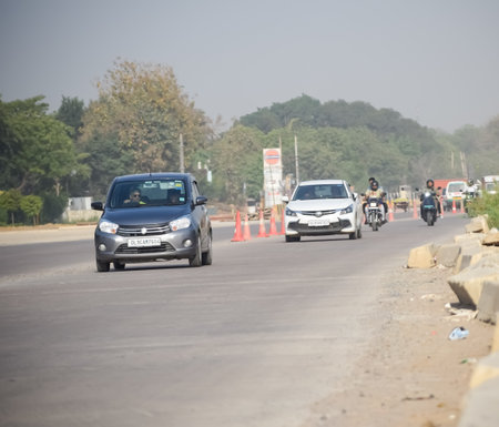 New Delhi, India - April 16, 2023 - View of Vehicles passing through the main road near Indra Gandhi...