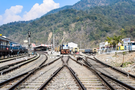 View of train Railway Tracks from the middle during daytime at Kathgodam railway station in India,...