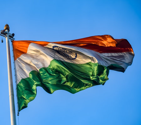 India flag flying high at Connaught Place with pride in blue sky, India flag fluttering, Indian Flag on Independence Day and Republic Day of India, tilt up shot, Waving Indian flag, Har Ghar Tirangaの写真素材