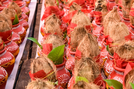 Kalash with coconut and mango leaf with floral decoration earthen pots containing sacred water....