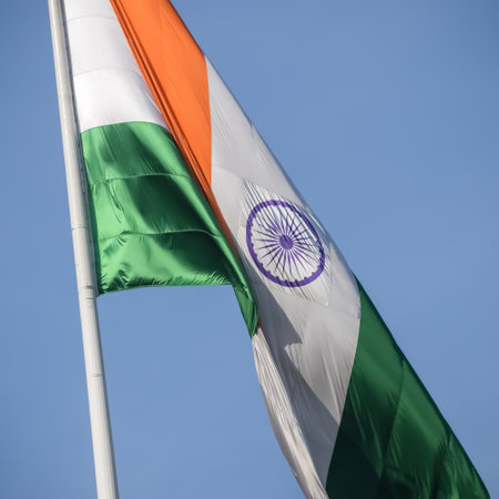 India flag flying high at Connaught Place with pride in blue sky, India flag fluttering, Indian Flag on Independence Day and Republic Day of India, tilt up shot, Waving Indian flag, Har Ghar Tirangaの写真素材