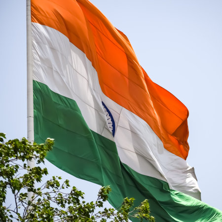 India flag flying high at Connaught Place with pride in blue sky, India flag fluttering, Indian Flag on Independence Day and Republic Day of India, tilt up shot, Waving Indian flag, Har Ghar Tirangaの写真素材