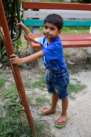 Asian boy doing routine exercise in society park during the morning time. Cute little kid exercise and gym to keep himself fit for life. Child exercise outdoor shootの写真素材