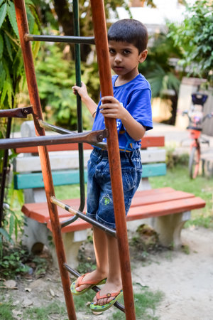 Asian boy doing routine exercise in society park during the morning time. Cute little kid exercise to keep himself fit for life. Child exercise outdoor shootの写真素材