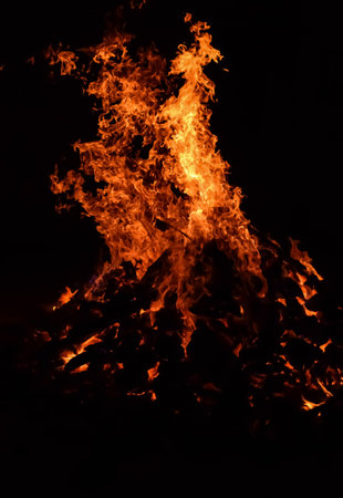 Fire flames on black background, Blaze fire flame texture background, Beautifully, the fire is burning, Fire flames with wood and cow dung bonfireの写真素材
