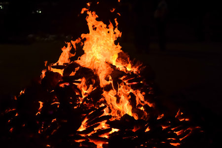 Fire flames on black background, Blaze fire flame texture background, Beautifully, the fire is burning, Fire flames with wood and cow dung bonfireの写真素材