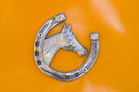 Detail of metallic horse shoe with horse headの写真素材