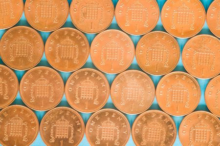 Pattern of one pence coins on a light blue background