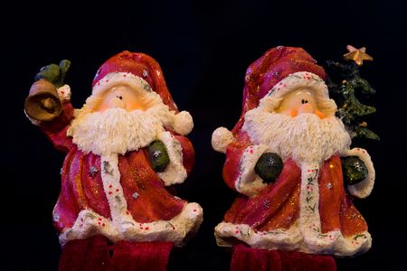 Pair of Santa Claus figurines isolated on blackの写真素材
