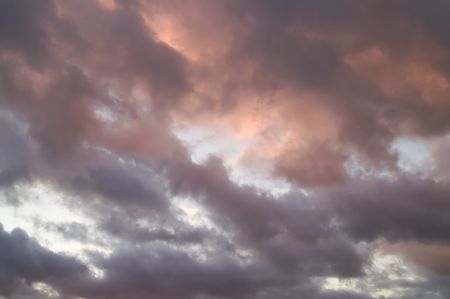 Dramatic and moody sunset cloudscape with warm tones