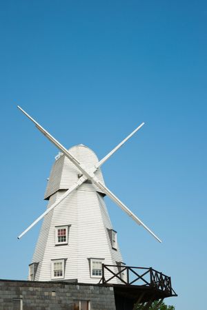 Old white wood windmill in Rye, Kent, against a clear blue skyの写真素材
