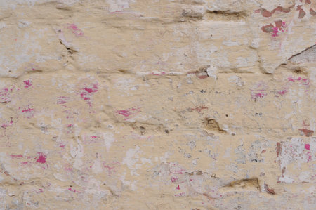 Background of an old brick wall covered with plaster and paint.の写真素材