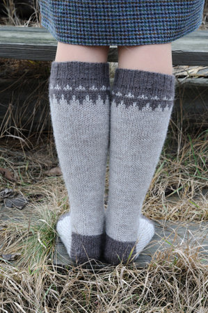 The girl's legs are dressed in handmade wool socks.の写真素材