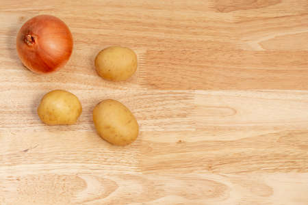 onion and potatoes on wooden table with copy space and space for textの写真素材