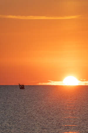 Sunrise in the mediterranean sea with fishing boatの写真素材