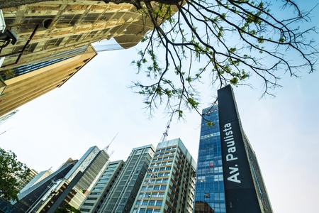 A view of Paulista avenue in the evening with the typical plaque with its name and the peculiar buildings of the financial center of São Pauloのeditorial素材