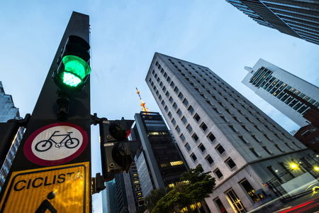 A view of Paulista avenue in the evening with the typical plaque with its name and the peculiar buildings of the financial center of São Pauloのeditorial素材